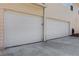 Attached two-car garage with a concrete driveway and neutral colored siding at 3485 Walnut Rdg, Atlanta, GA 30349