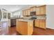 Kitchen featuring wood cabinets, granite countertops, stainless steel appliances, and an island at 3485 Walnut Rdg, Atlanta, GA 30349