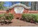 Entrance to Regency Oaks neighborhood with a brick sign surrounded by landscaping at 3485 Walnut Rdg, Atlanta, GA 30349