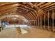 Unfinished attic space with exposed beams and plywood flooring at 3715 Borning Ct, Johns Creek, GA 30022