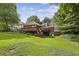 Lush backyard with a spacious deck, perfect for outdoor entertaining and relaxation, set against a backdrop of mature trees at 3715 Borning Ct, Johns Creek, GA 30022
