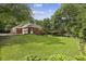 Expansive backyard offering ample space for recreation, featuring a well-manicured lawn and mature trees providing shade at 3715 Borning Ct, Johns Creek, GA 30022