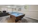 Basement featuring a pool table with light blue felt and a brown wooden frame, ready for endless hours of entertainment at 3715 Borning Ct, Johns Creek, GA 30022