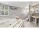 Bright and airy bathroom with a soaking tub, walk-in shower, and elegant fixtures, providing a serene and comfortable space at 3715 Borning Ct, Johns Creek, GA 30022