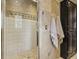 Bathroom featuring a tiled walk-in shower and built-in cabinet at 3715 Borning Ct, Johns Creek, GA 30022