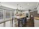 Spacious kitchen features a large island, stainless steel appliances, and white cabinetry with modern fixtures at 3715 Borning Ct, Johns Creek, GA 30022