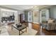Open-concept living room flows to the dining room with hardwood floors and stylish furniture at 3715 Borning Ct, Johns Creek, GA 30022