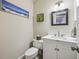 Updated powder room features a modern vanity, framed mirror, and stylish lighting at 3715 Borning Ct, Johns Creek, GA 30022