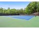 Community tennis courts featuring bright blue courts and a black fence at 3715 Borning Ct, Johns Creek, GA 30022