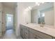 Bright bathroom featuring a double sink, white countertop, large mirror, and tile flooring at 129 Henley St, Canton, GA 30114