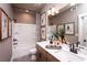Modern bathroom with double vanity, framed mirrors, and shower-tub combination at 129 Henley St, Canton, GA 30114