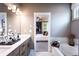 Elegant bathroom featuring a soaking tub and a view to the bedroom at 129 Henley St, Canton, GA 30114