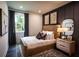 This bedroom features a wooden bed frame, large window, stylish lighting, and decor at 129 Henley St, Canton, GA 30114
