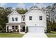 Beautiful two-story home with white siding, a charming front porch, and well-maintained landscaping at 129 Henley St, Canton, GA 30114