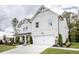 Elegant two-story farmhouse style home with white vertical siding and a well-manicured lawn at 129 Henley St, Canton, GA 30114