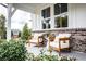 Inviting front porch with brick accents and comfortable chairs at 129 Henley St, Canton, GA 30114