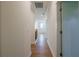 Hallway with hardwood floors, white walls, and white doors with bronze hardware at 129 Henley St, Canton, GA 30114