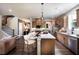 Open kitchen with a large island, stainless steel appliances, light-colored cabinets, and hardwood floors at 129 Henley St, Canton, GA 30114