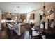 Bright kitchen features an island, stainless steel appliances, pendant lights, and hardwood floors at 129 Henley St, Canton, GA 30114