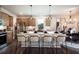 Bright, modern kitchen with an island, stainless steel appliances, pendant lights, and hardwood floors at 129 Henley St, Canton, GA 30114