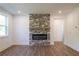 Living room featuring a modern stone fireplace with a wooden mantel at 129 Henley St, Canton, GA 30114
