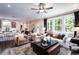 Spacious living area with hardwood floors, lots of natural light, and a view into the kitchen area at 129 Henley St, Canton, GA 30114