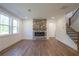 Living room with a stone fireplace, hardwood-style flooring and staircase at 129 Henley St, Canton, GA 30114