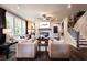 Open concept living room with hardwood floors, fireplace, and large windows for natural light at 129 Henley St, Canton, GA 30114