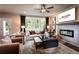 Bright living room with a fireplace, hardwood floors, large windows, and comfortable seating at 129 Henley St, Canton, GA 30114
