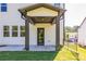 A covered back patio features dark stained columns, concrete flooring, and a metal fence at 129 Henley St, Canton, GA 30114