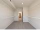 Walk-in closet with white walls, carpeted floors, wire shelving, and access to another room at 129 Henley St, Canton, GA 30114