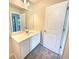 Bright bathroom featuring a white vanity with solid surface countertop, and decorative lighting at 1958 Millstream Holw, Conyers, GA 30012