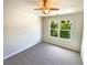 Cozy bedroom with soft carpet, fan and a view of the neighborhood at 1958 Millstream Holw, Conyers, GA 30012