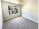 Bedroom featuring soft carpet, a ceiling fan, and a window with a neighborhood view at 1958 Millstream Holw, Conyers, GA 30012