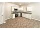 Kitchen with stainless steel appliances, white cabinets, and granite countertops at 1958 Millstream Holw, Conyers, GA 30012