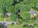 Secluded homes are surrounded by a canopy of green trees in this aerial view at 6590 Williamson Ne Dr, Atlanta, GA 30328