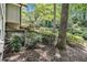Backyard featuring a multilevel deck surrounded by mature trees and lush landscaping at 6590 Williamson Ne Dr, Atlanta, GA 30328