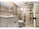 Updated bathroom features a glass-enclosed shower, modern vanity, and tiled floors at 6590 Williamson Ne Dr, Atlanta, GA 30328