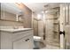 Bathroom featuring a glass door shower, toilet and large vanity cabinet at 6590 Williamson Ne Dr, Atlanta, GA 30328