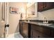 Bathroom with double vanity featuring dark cabinets and a large mirror, accented by modern fixtures at 6590 Williamson Ne Dr, Atlanta, GA 30328