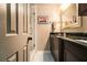 Modern bathroom features dark vanity with granite counters, tiled floor, and glass-enclosed shower at 6590 Williamson Ne Dr, Atlanta, GA 30328