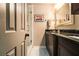 Bright bathroom with double sinks, framed mirror, dark wood cabinets, and a glass door shower at 6590 Williamson Ne Dr, Atlanta, GA 30328