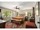 Comfortable bedroom featuring hardwood floors, ceiling fan, and abundant natural light from large windows at 6590 Williamson Ne Dr, Atlanta, GA 30328