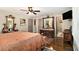 A view of the bedroom featuring hardwood floors, a ceiling fan, and an oversized bed at 6590 Williamson Ne Dr, Atlanta, GA 30328