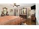 Spacious bedroom showcasing dark hardwood floors, antique furniture, and a ceiling fan for added comfort at 6590 Williamson Ne Dr, Atlanta, GA 30328