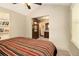 Bright bedroom with vaulted ceiling, built-in shelving, and an open doorway to the ensuite bathroom at 6590 Williamson Ne Dr, Atlanta, GA 30328