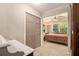 Cozy bedroom with plush carpeting, natural light, and closet access at 6590 Williamson Ne Dr, Atlanta, GA 30328