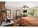 Large bedroom featuring hardwood floors, antique furniture, and a ceiling fan for climate control at 6590 Williamson Ne Dr, Atlanta, GA 30328