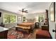 Spacious bedroom with hardwood floors, large windows, a ceiling fan and a decorative rug at 6590 Williamson Ne Dr, Atlanta, GA 30328