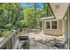 Wooden deck with a mix of stone and wooden decking, with views of the surrounding trees at 6590 Williamson Ne Dr, Atlanta, GA 30328